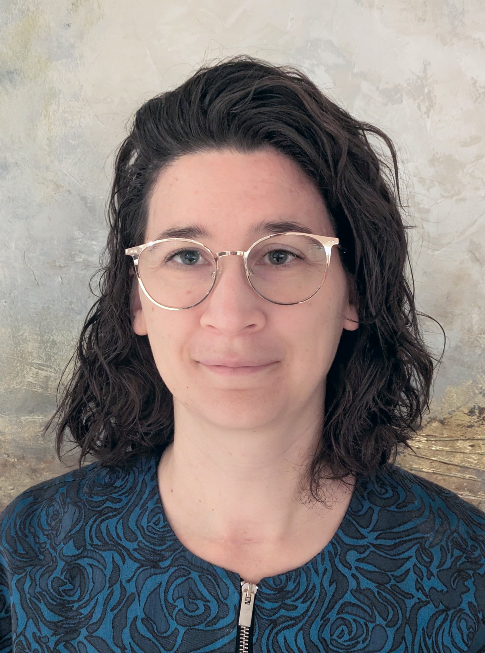 En person med briller som smiler