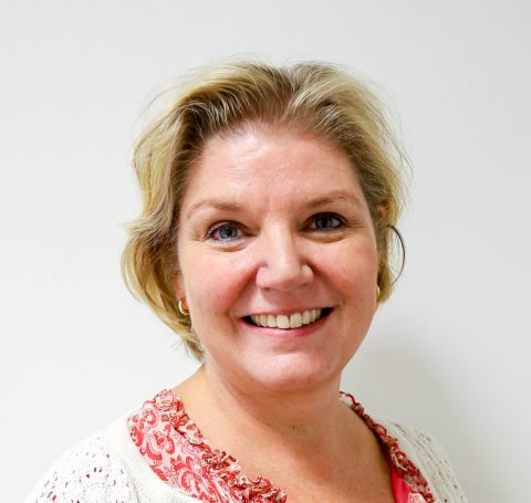 A close-up of a woman smiling