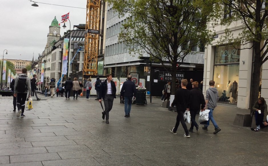 A group of people walking on a street